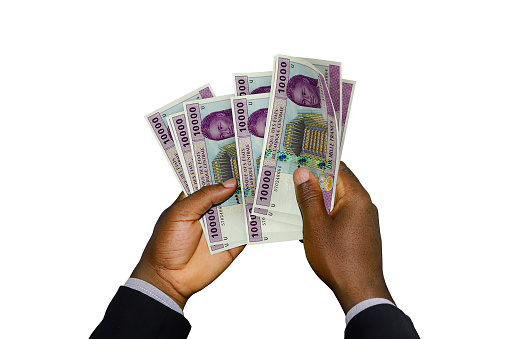 Black Hands in suit holding 3D rendered Central African CFA franc notes